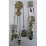 A Victorian electroplated chatelaine, the cast top decorated with children, four chain