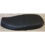 A c.2012/13 Triumph T100 seat, part number 2301932/2301935, unused.