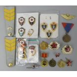 A Soviet era selection of Russian and Iron Curtain of enamelled army, navy and air force badges,