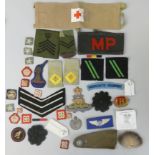 A military police armband of red letters on black, a Red Cross armband stamped "Inspectie Militair