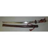 A Japanese military issue Katana having a 68.5cm single edged blade, a wavy edged hammon, copper