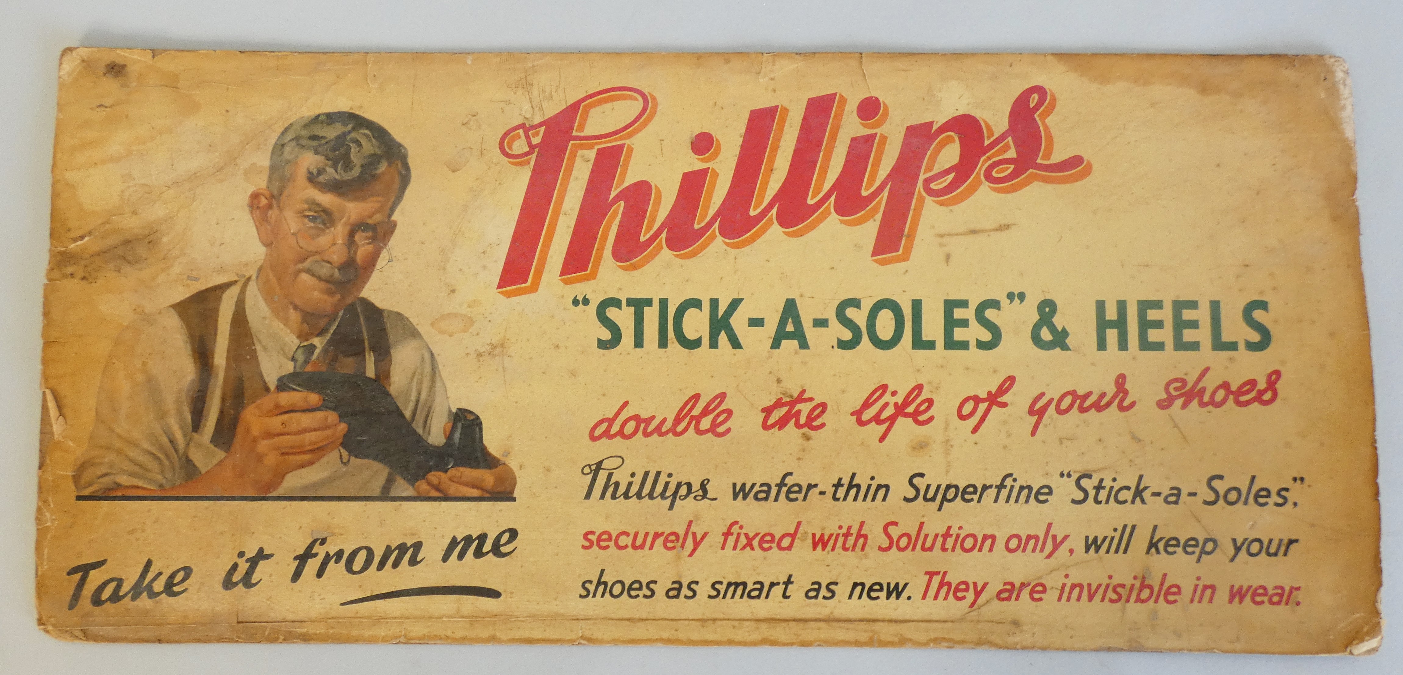 An advertising sign for Phillips "Stick-A-Soles" and Heels, "double the life of your shoes, Phillips