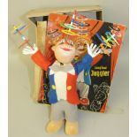 A German clockwork 'The Famous Juggler', the composition headed clown dressed in felt, spinning