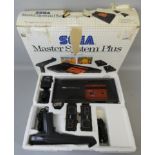 A boxed Sega Master System Plus video game system, with light phaser, control pads and power base,