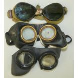 Three pairs of WWII German goggles, one pair with triple glass and black bakelite fittings, a
