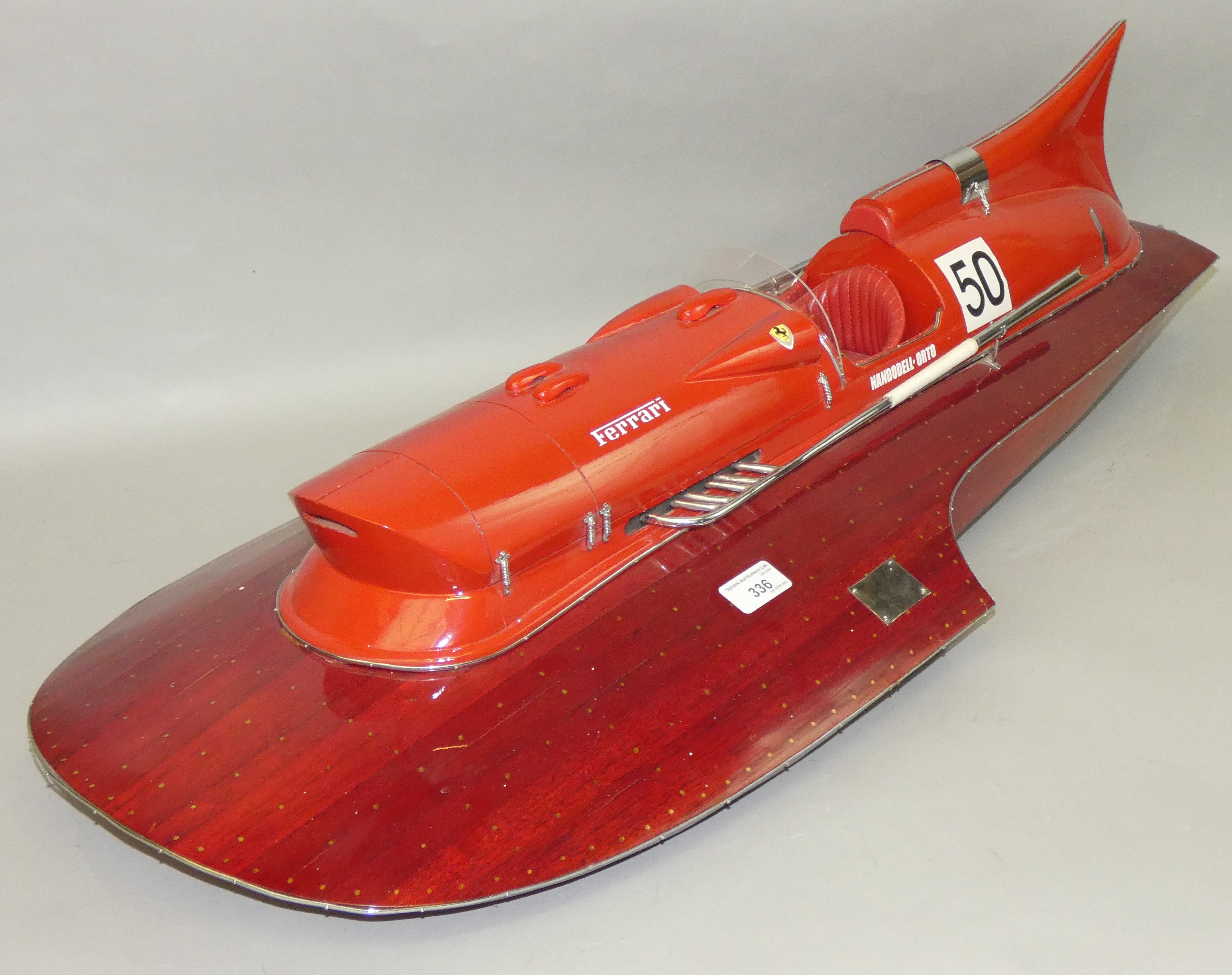 A model of Castoldi's 1953 Ferrari Hydroplane, with planked wooden hull and padded leather set.