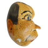 A fossilised whales ear drum painted with the face of a man, length 13cm. Provenance; his was