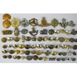 A quantity of mostly British army buttons and badges including, Green Howards, military police,