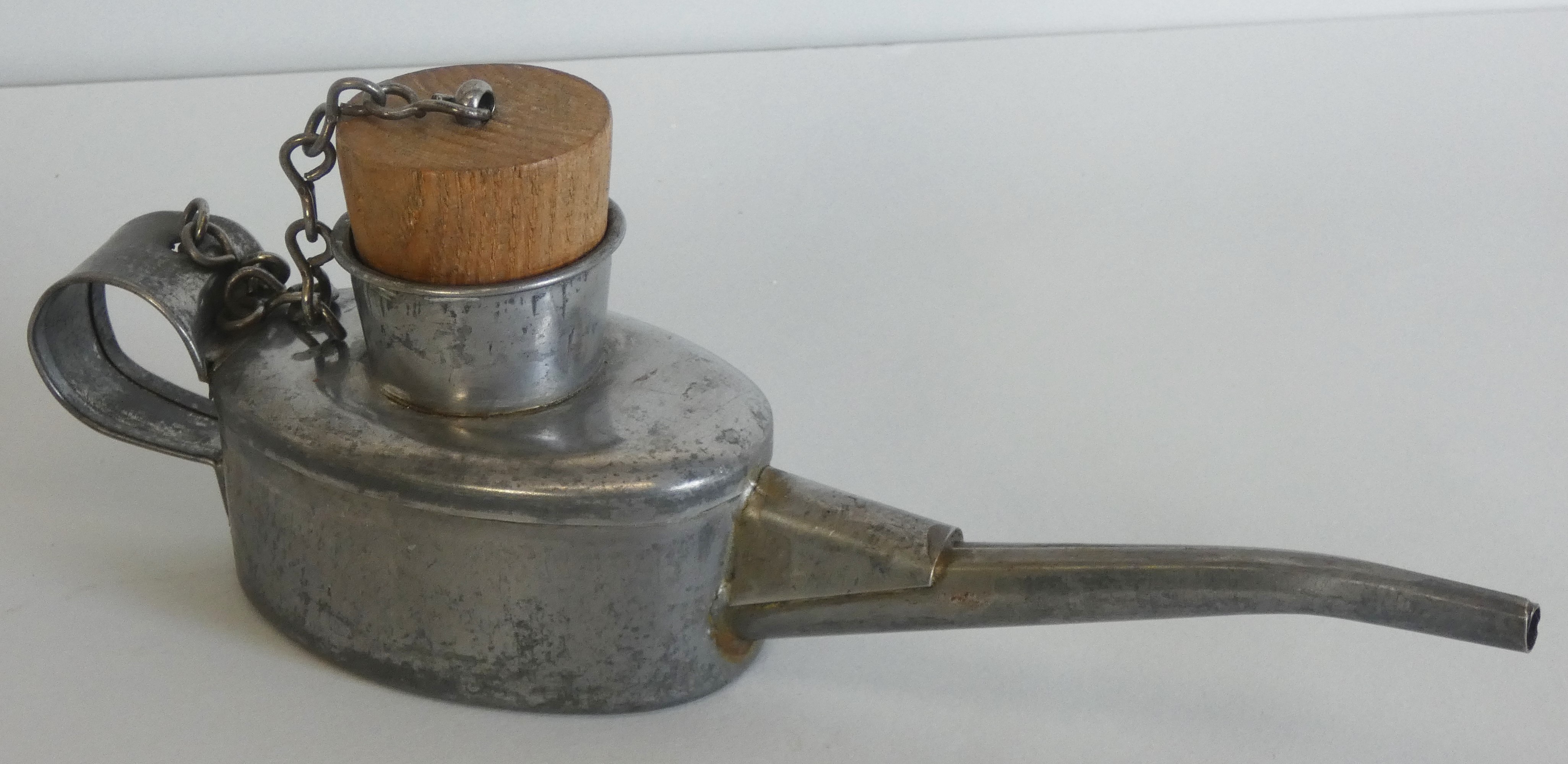 A small railway engine drivers’ oil can (ex stores), with oak stopper on metal chain, height 8.5cm.
