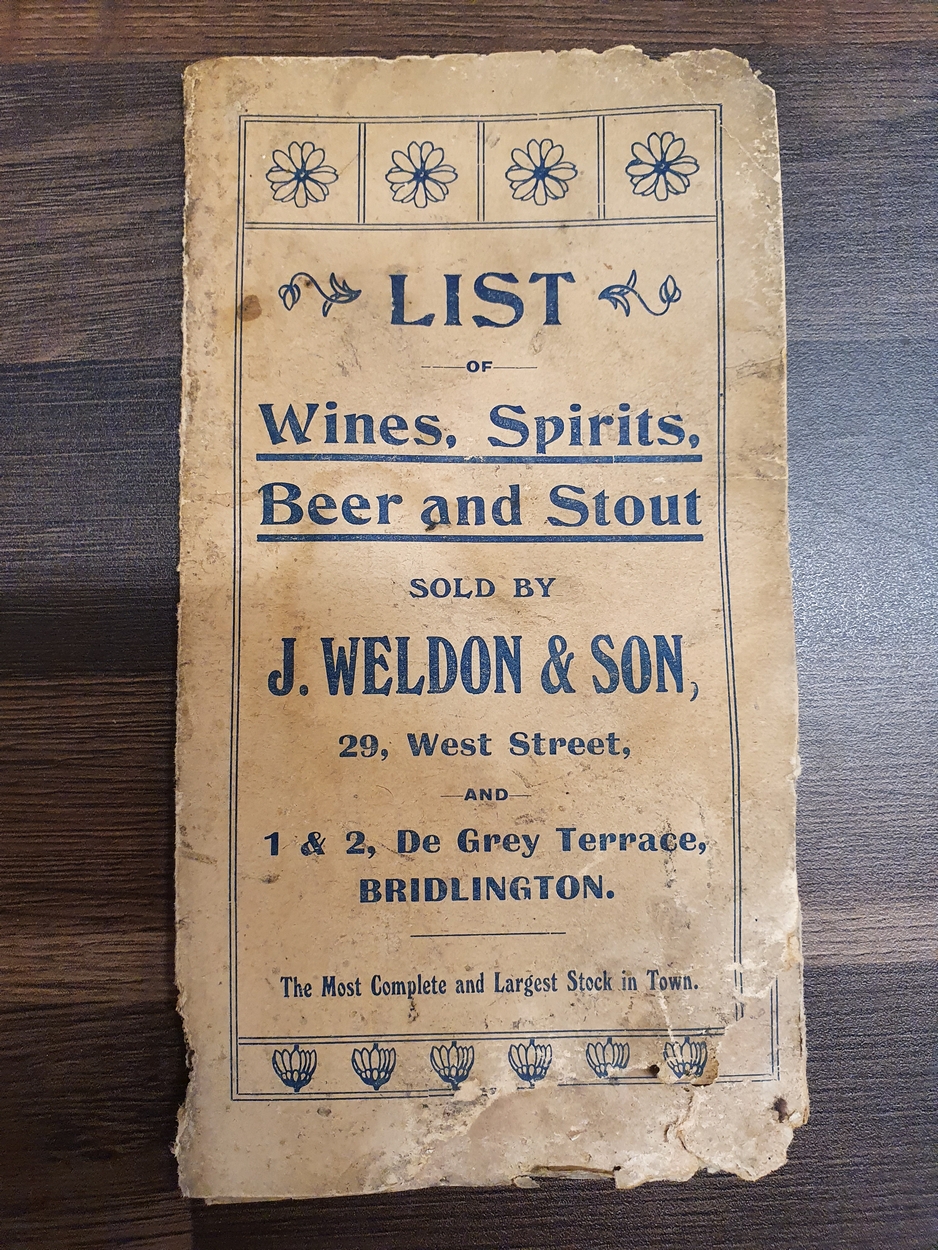 An Edwardian blue canvas roller shop banner, white painted "J. Wildon & Sons.....", 220 x 355 cm - Image 2 of 3