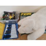 A TCR slot car game, a train set, a musical instrument and a cuddly toy.