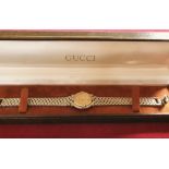 A Gucci ladies stainless steel and gilt metal quartz wristwatch, model 9000L, box.