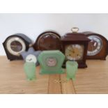 An Art Deco green moulded glass clock garniture, three mantle clocks and two other clocks (8).