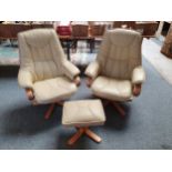 A pair of Danish Somo beige leather fronted and laminated birch reclining swivel armchairs with a