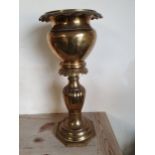 A brass jardiniere with gadrooned border, raised on a matching baluster stand, 65 cm.