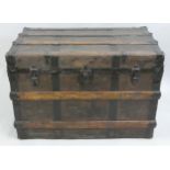 A Victorian travelling trunk, the canvas panels overlaid with wood and metal bands, raised on