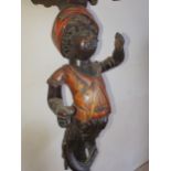 A late 19th century Blackamoor pedestal table, the painted figure to a tripod base, AF, height 73