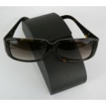 Prada, a pair of tortoiseshell sunglasses, model SPR 16L, guarantee, certificate card, polish cloth,