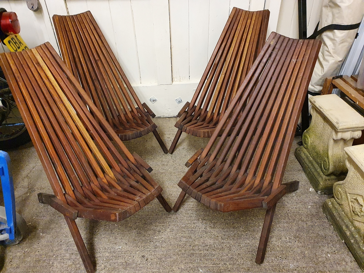 A set of four folding hardwood garden chairs.