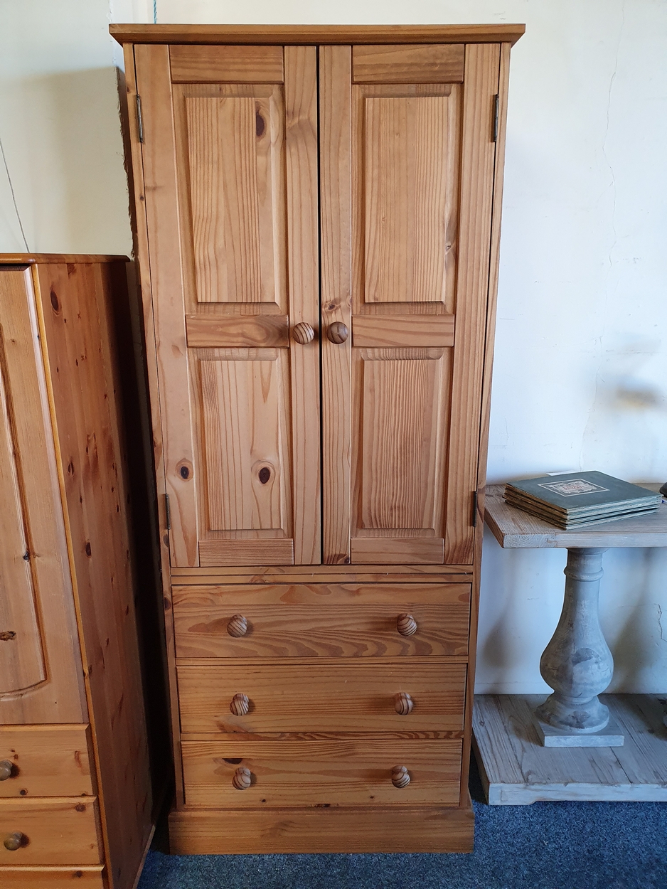 A pine wardrobe, of two doors over three drawers, 76 x 55 x 185 cm.