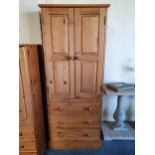 A pine wardrobe, of two doors over three drawers, 76 x 55 x 185 cm.