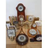 A brass anniversary clock with glass dome, two others with plastic domes, together with various