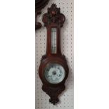 An Edwardian carved oak aneroid barometer, retailed by J. Gardiner, Hull, 65 cm.