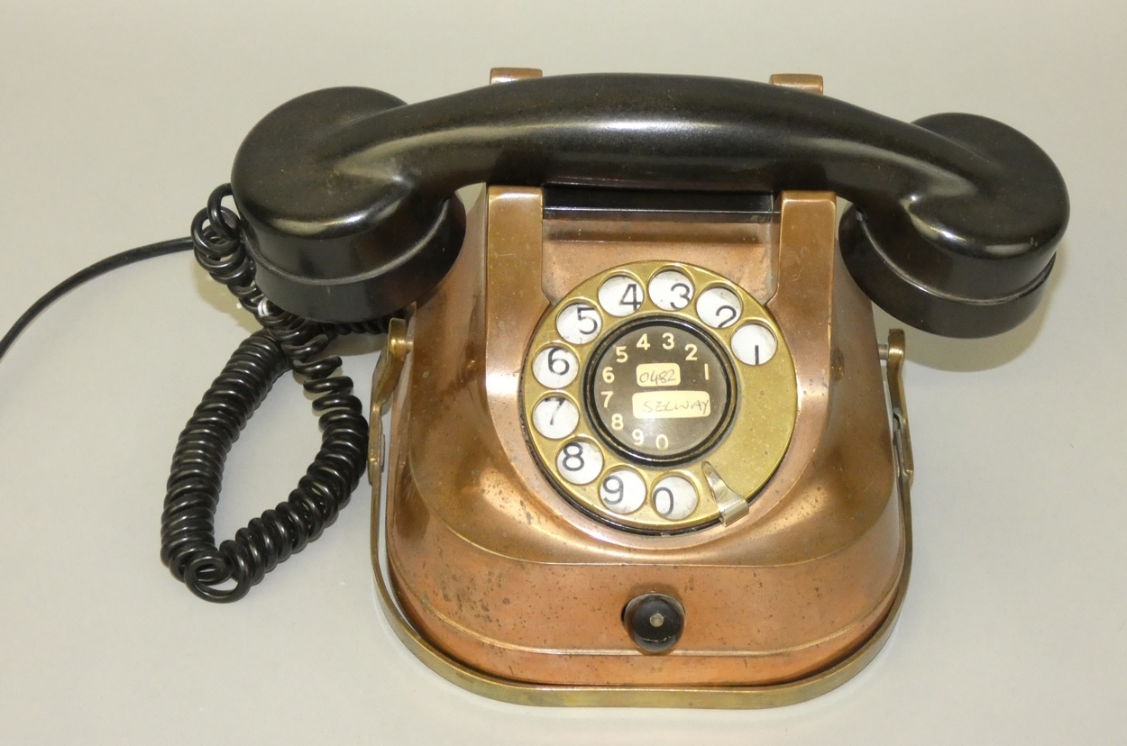 A Belgium copper body telephone, with brass carry handle and dial, converted.