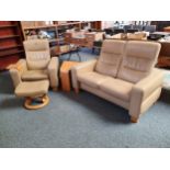 A Norwegian Ekornes Stressless beige leather two seater reclining sofa with matching armchair, stool