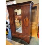 An Edwardian mahogany single wardrobe with mirrored door over single drawer, 130 x 52 x 104 cm.