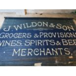 An Edwardian blue canvas roller shop banner, white painted "J. Wildon & Sons.....", 220 x 355 cm