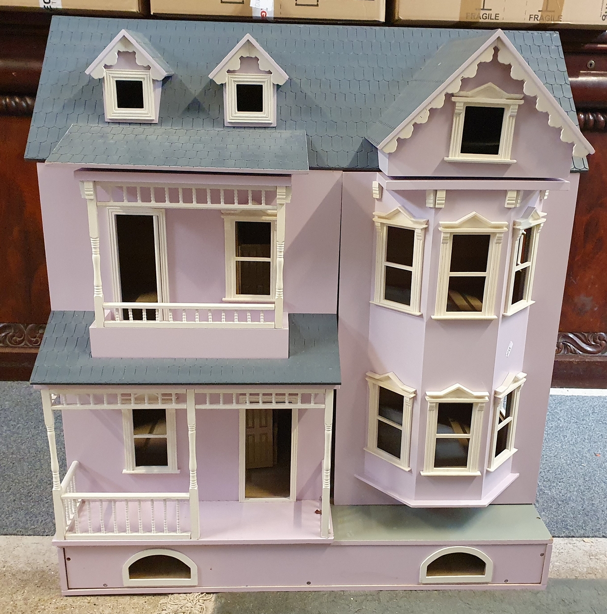 A scratch built large dolls house, the double opening front and lifting roof, storage drawer