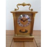 A West German brass 8 day mantle clock, with visible pendulum, ht 19cm.