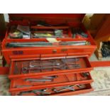 A six drawer tool chest with various spanners and other tools.