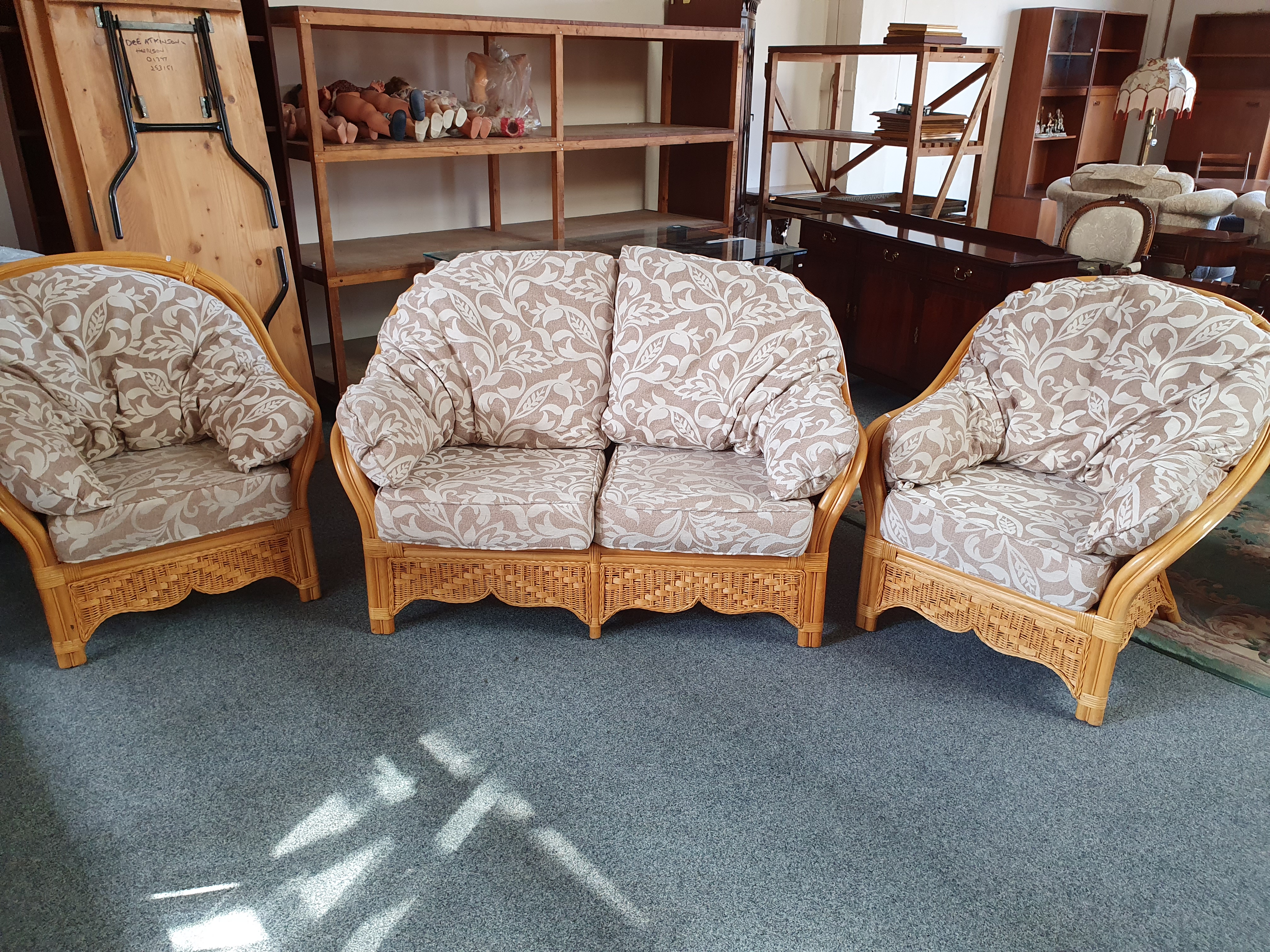 A cane three piece conservatory suite, two seater sofa and two armchairs (3).