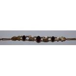 A gold bracelet set with garnets between Egyptian motifs, weight 8.5g