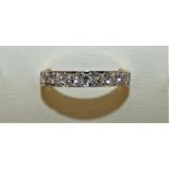An 18ct gold 9 stone diamond ring channel set with brilliant cut stones, approx. 0.45 cts, weight