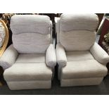 A pair of electric reclining armchairs