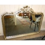 A bevel edge over mantle mirror of shaped form with silvered frame 100x125cm