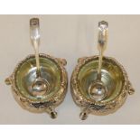 A pair of Victorian silver cauldron salts, London 1853 with embossed decoration and later fiddle,