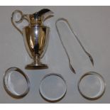 A silver cream jug, Sheffield 1902 of vase form, three silver napkin rings and a pair of sugar