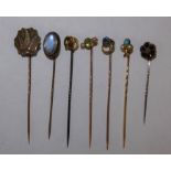 A gold turquoise and pearl stickpin, a peridot and pearl stick and 5 other sticks