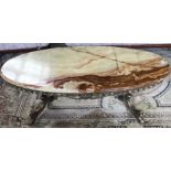 An oval marble topped coffee table, raised on a brass twin pedestal base, 120 x 54 x 46 cm.