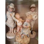 A Continental painted girl and boy with pond yacht, 44 cm and another with boy and girl and a
