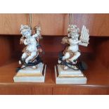 A pair of resin table lamps in form of musical cherubs, 30cm, with tassel shades (2)