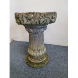 A concrete garden two part bird bath, with ivy border, height 53 cm.