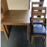 A light oak square dining table, 80 x 80 x 76 cm, together with two matching chairs (3).