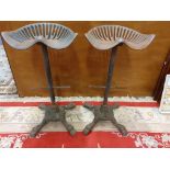 A pair of cast iron tractor type bar stools (2).