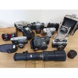 A collection of cameras, to include an Olympus Pen FT camera with lens, a plate camera