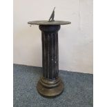 A painted concrete pedestal with metal sundial, inscribed 'Grow old along with me, the best is yet